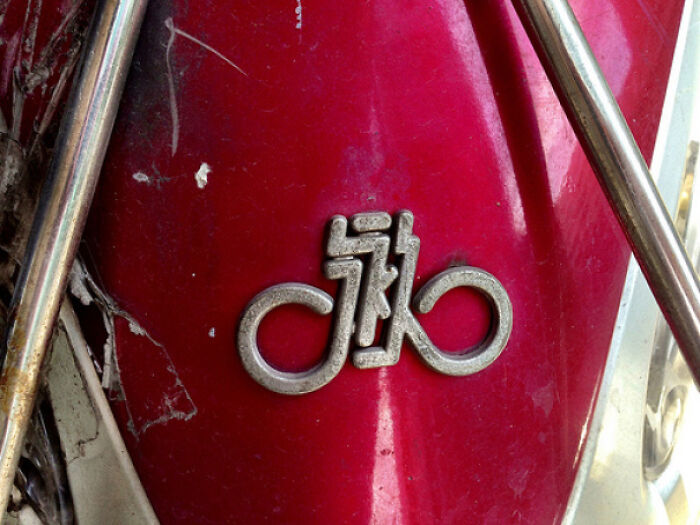 Creative designer logo on a red surface with unique shape