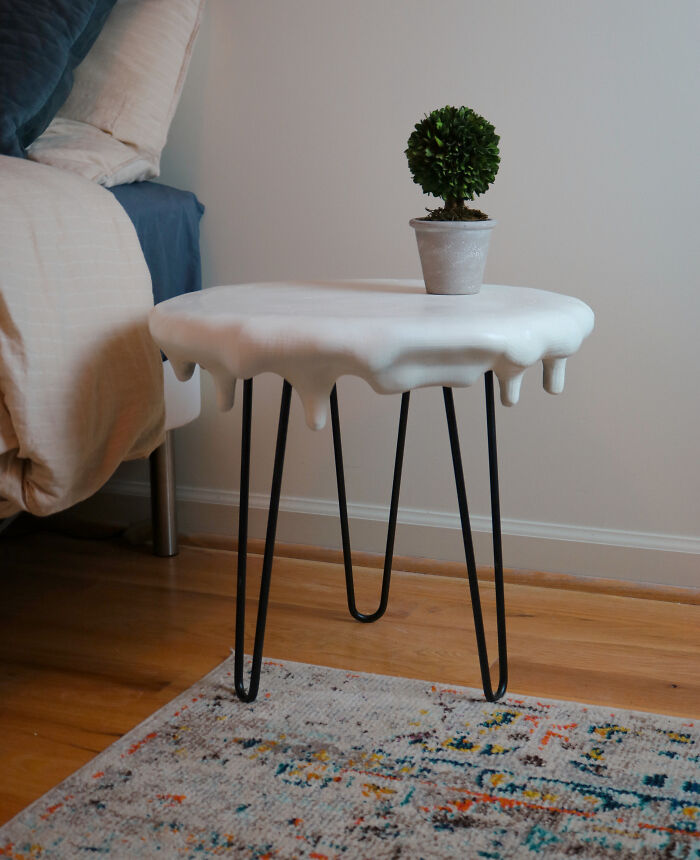 Modern side table with melting white top and black hairpin legs
