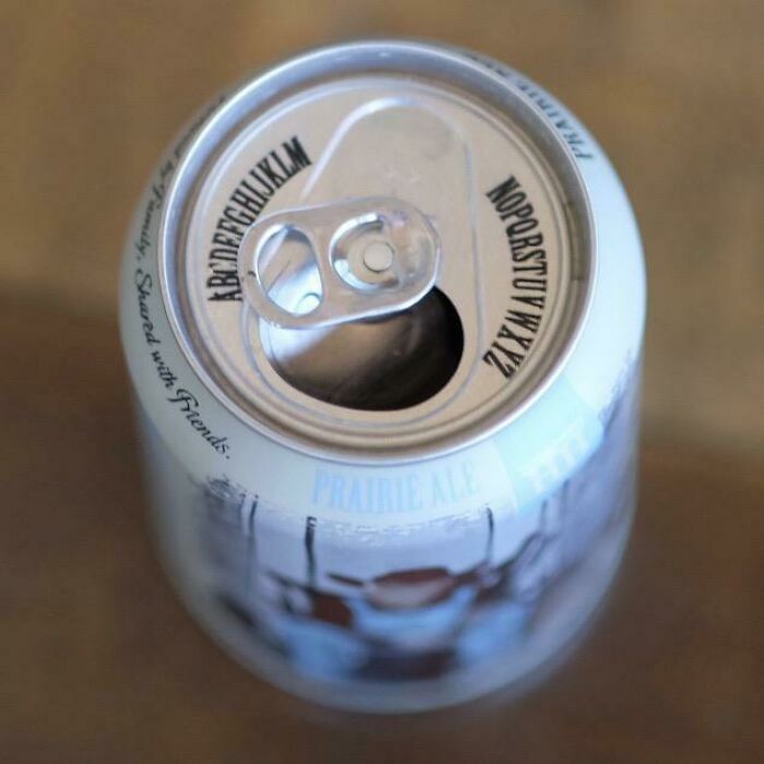 Creative beer can with alphabet printed around the opening tab