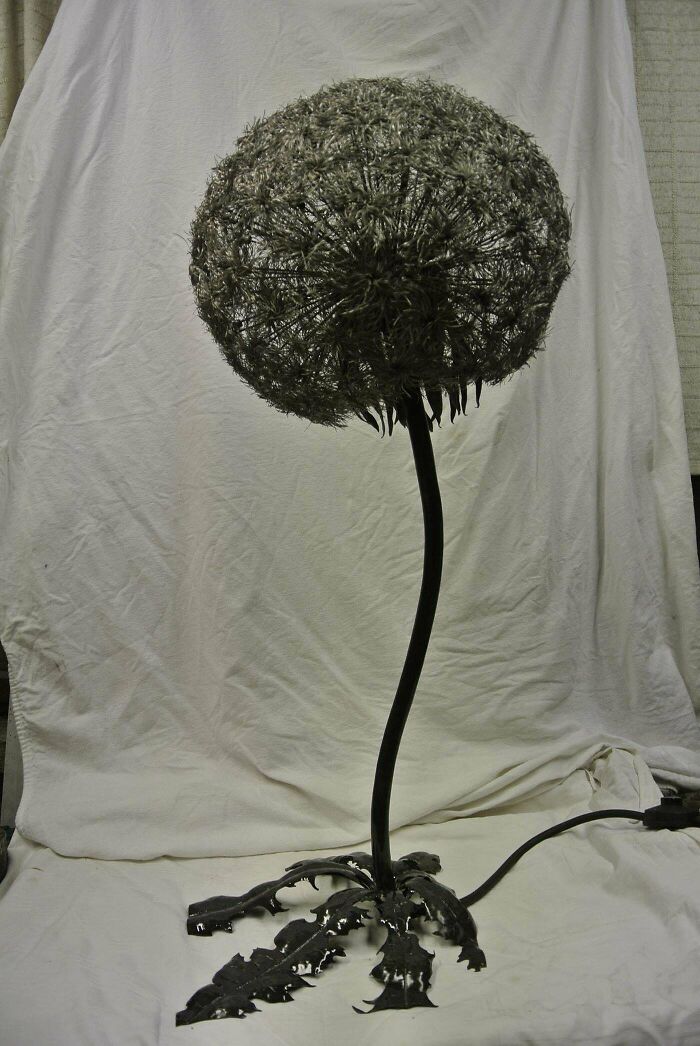 Metal sculpture of a dandelion flower made with artistic metalwork