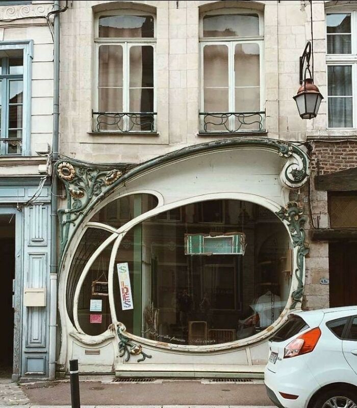 Art nouveau inspired creative storefront with large unique window frame