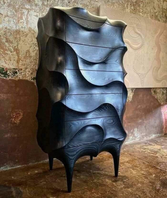 Creative wooden dresser with wave-like carved design and dark finish
