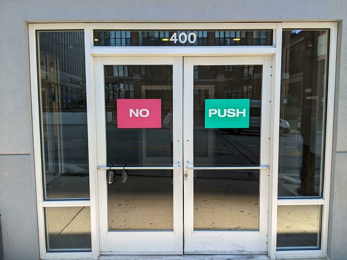 Creative designers used signs with conflicting messages on glass doors