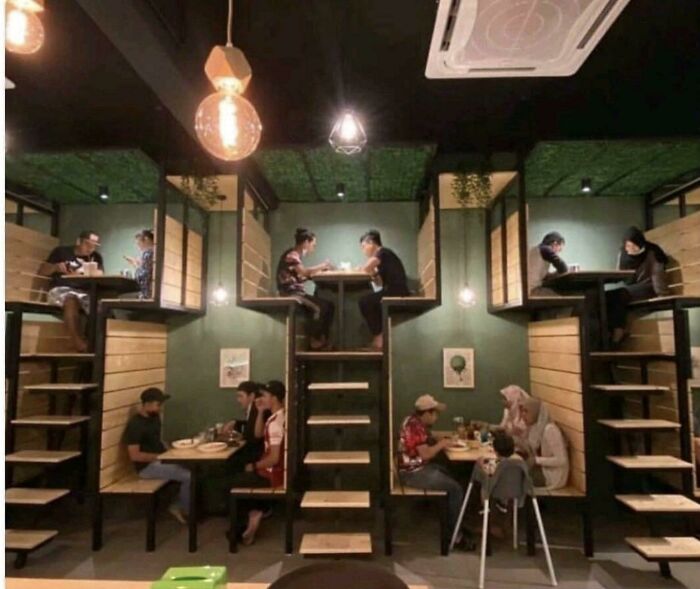 Innovative restaurant booth design with elevated and ground seating areas