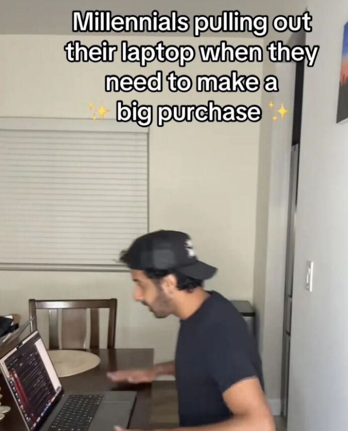 Millennial pulling out laptop to research big purchase decision