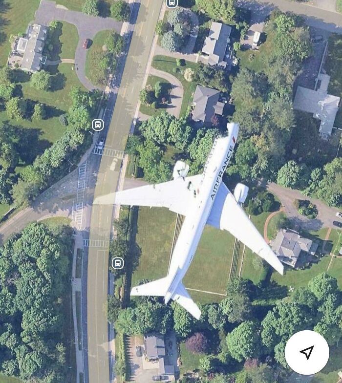 Aerial view screenshot showing an Air France airplane overlapping a residential neighborhood