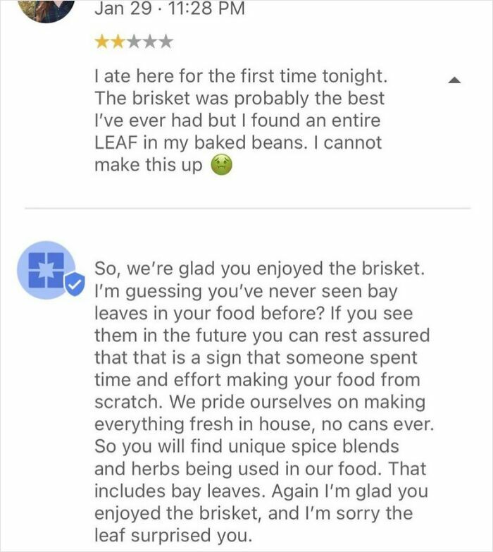 A funny online review about finding a bay leaf in baked beans, and the restaurant's humorous reply explaining it.