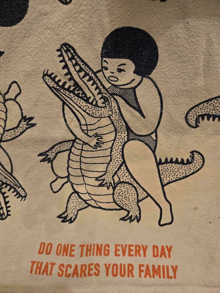 Humorous linen print of child riding alligator with caption about scaring family