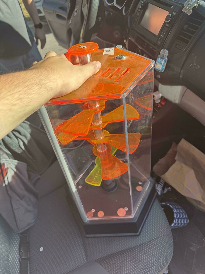 Transparent acrylic coin bank with orange spinning blades found thrifting