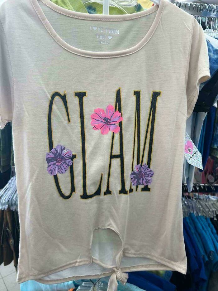 A light pink clothing design with the word 'Glam' and pink and purple flowers, illustrating a bad clothing design.