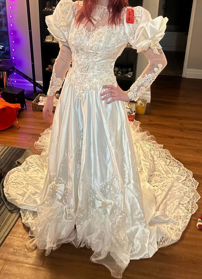 Elegant white lace and satin wedding dress found at Goodwill thrift store