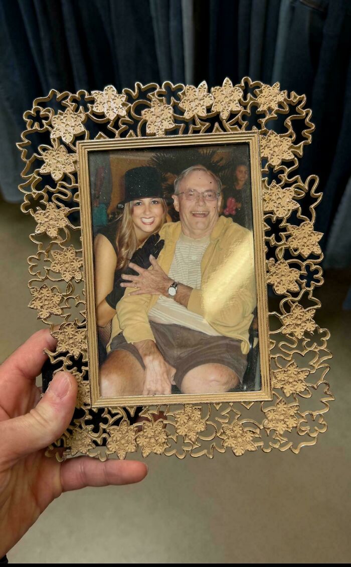 Ornate flower-patterned frame holding old photo found while thrifting