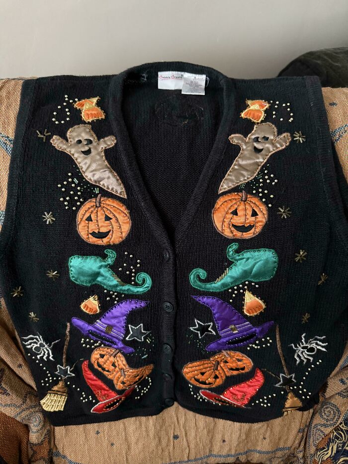 Black Halloween themed vest with pumpkins, ghosts, witches, and spider decorations