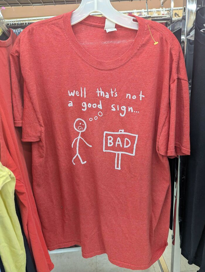 Funny goodwill find red t-shirt with bad sign pun and stick figure drawing