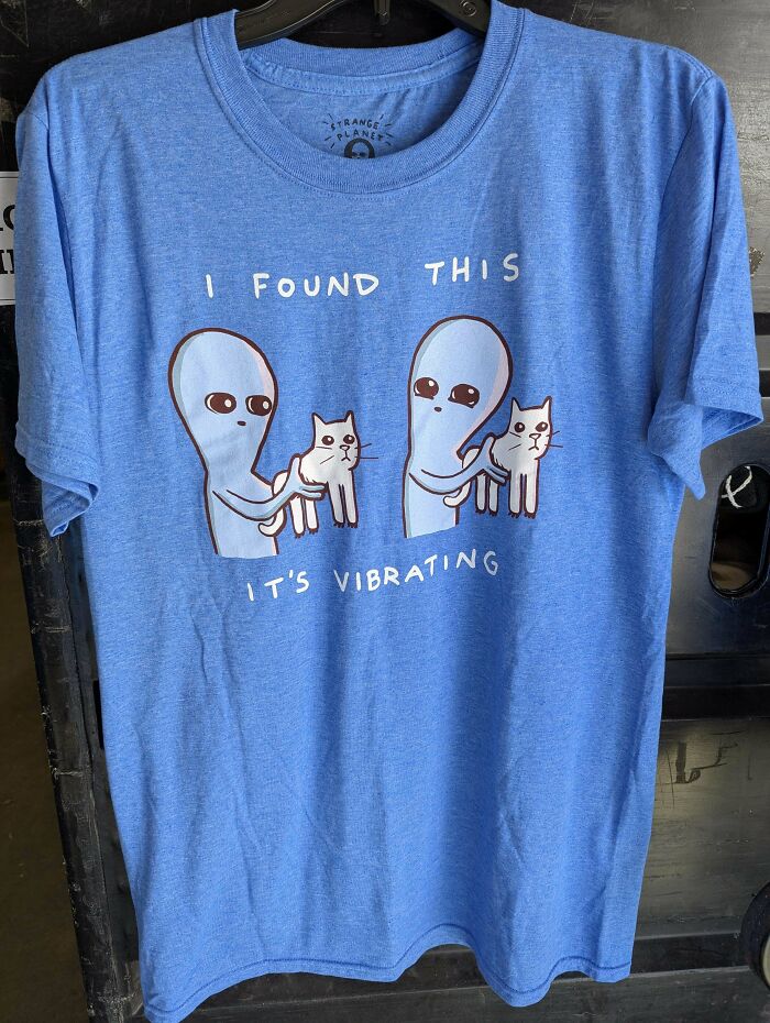 Blue goodwill t-shirt with aliens holding vibrating cats graphic