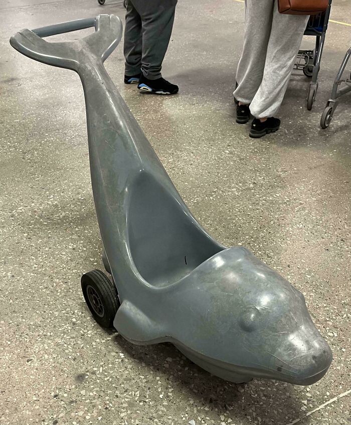 Gray plastic dolphin-shaped kids ride-on toy found at thrift store