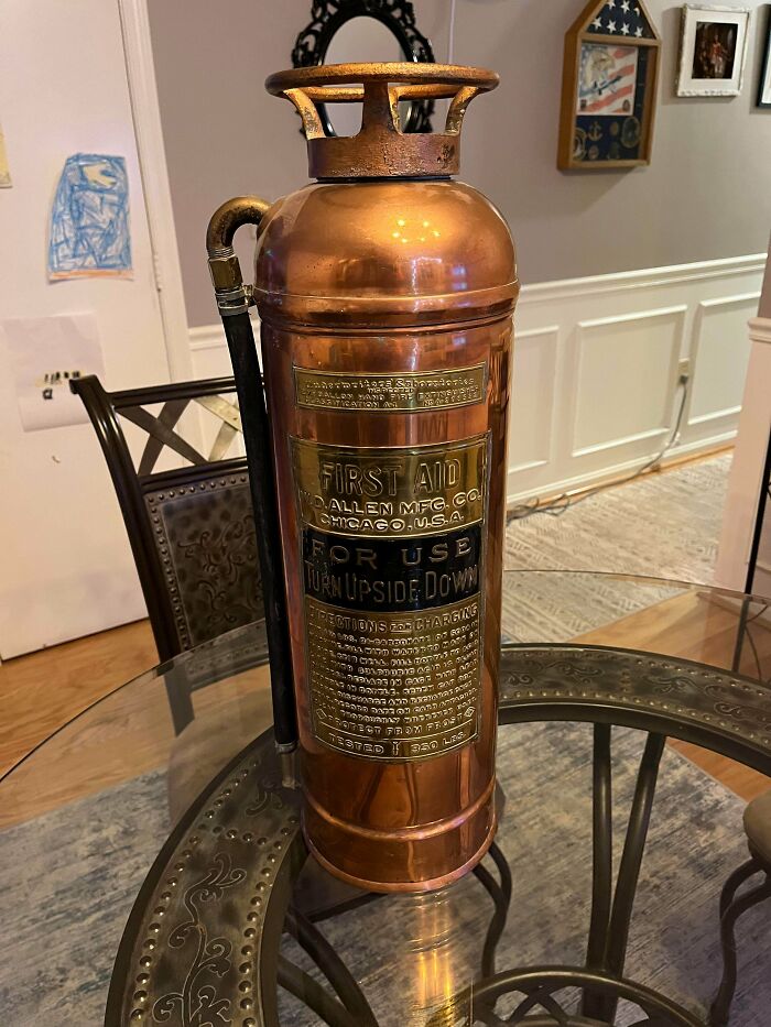 Vintage copper fire extinguisher with detailed inscriptions and label from thrift shop
