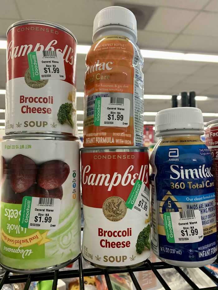 Cans of broccoli cheese soup and infant formula marked with Goodwill price tags