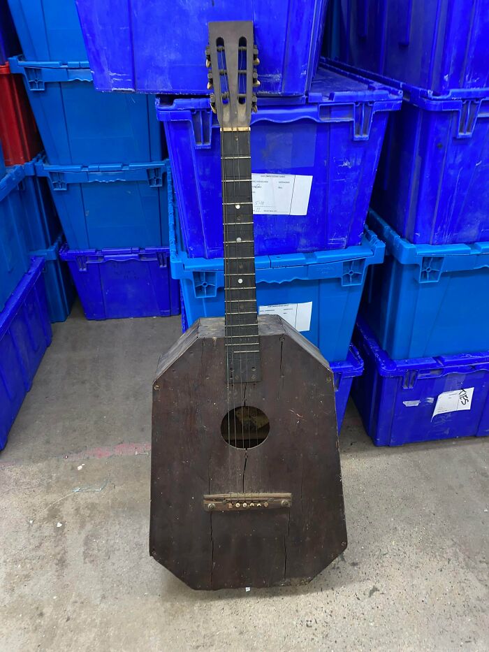 Old wooden guitar with an unusual shape found at a Goodwill thrift shop