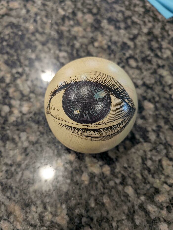 Wooden ball with detailed eye illustration found at Goodwill thrift store