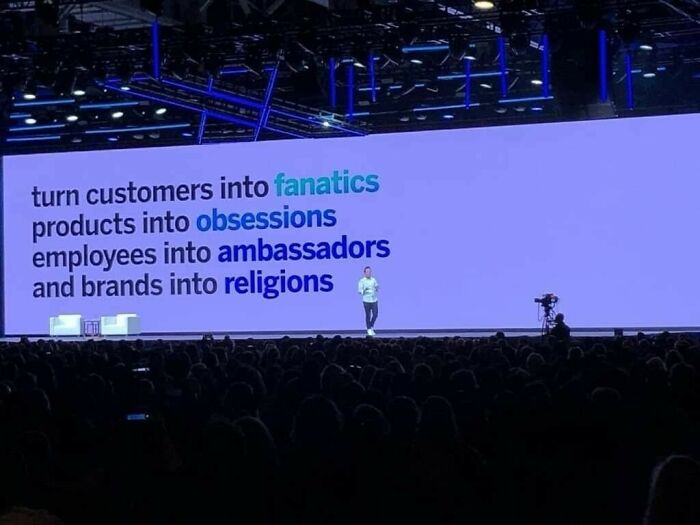 Conference slide on turning customers into fanatics and brands into religions