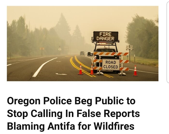 Road closed sign with fire danger warning in smoky area
