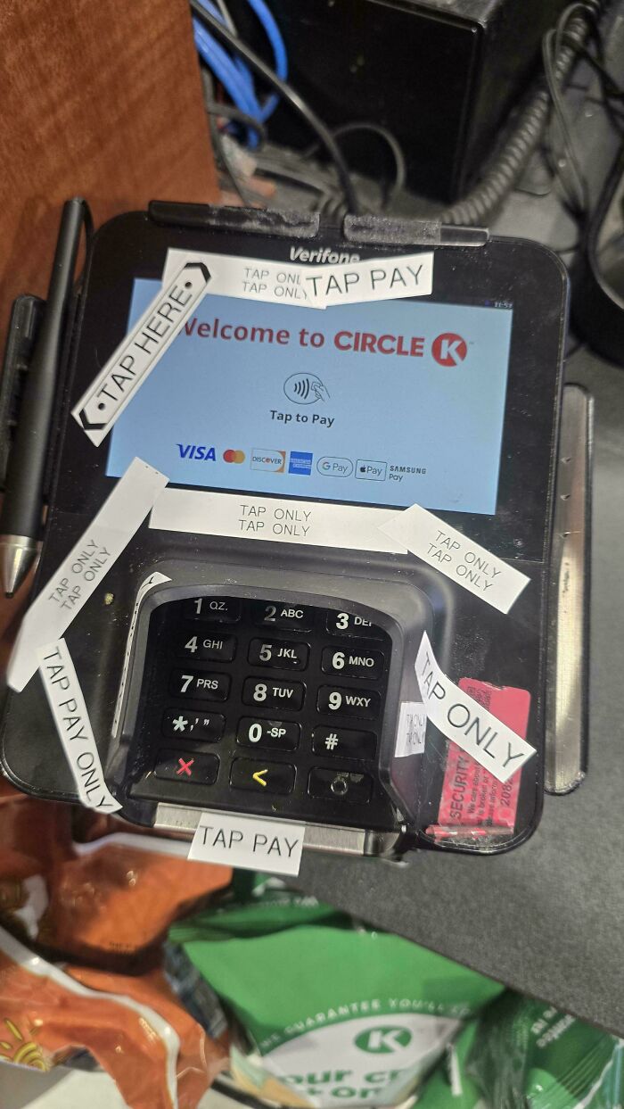 Retail payment terminal covered with tap pay only stickers at Circle K