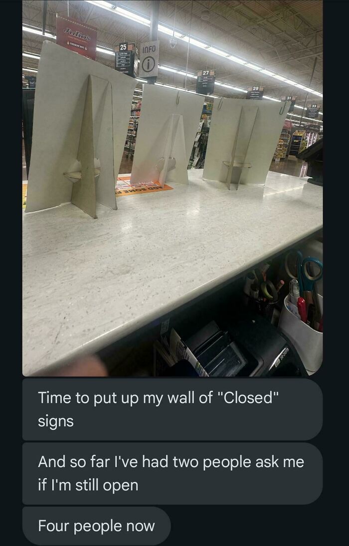 Grocery store counter with multiple closed signs standing on display