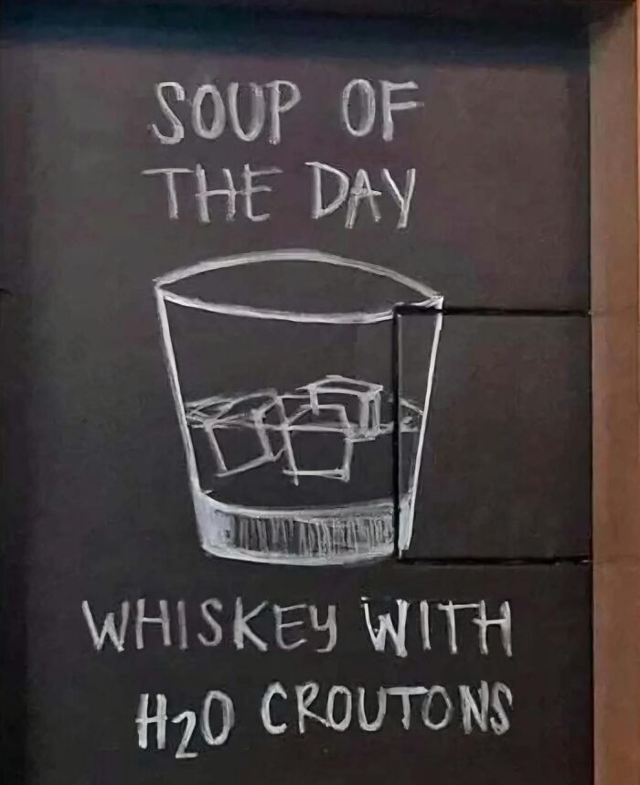 Chalkboard with humorous soup of the day whiskey with ice croutons