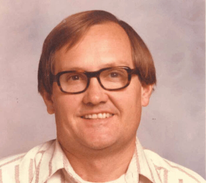 Man with glasses smiling in vintage horror stories image