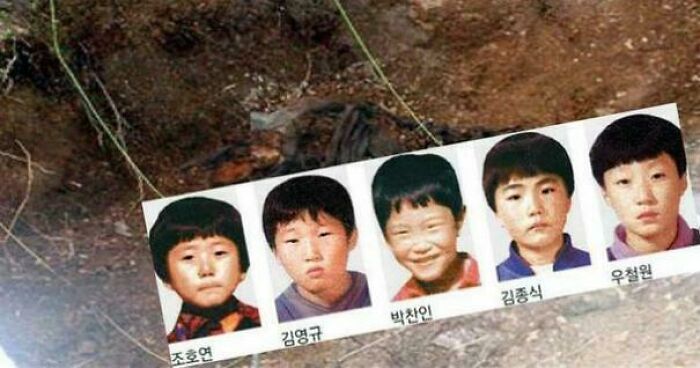 Photos of missing children displayed above a dirt ground
