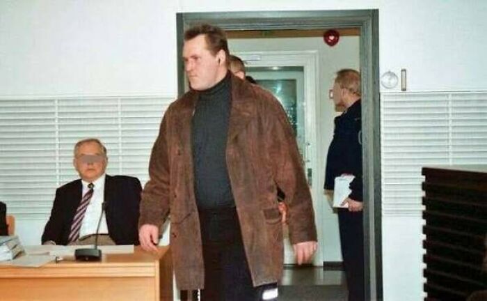 Man in brown jacket walking in a courtroom scene from a real terrifying horror story