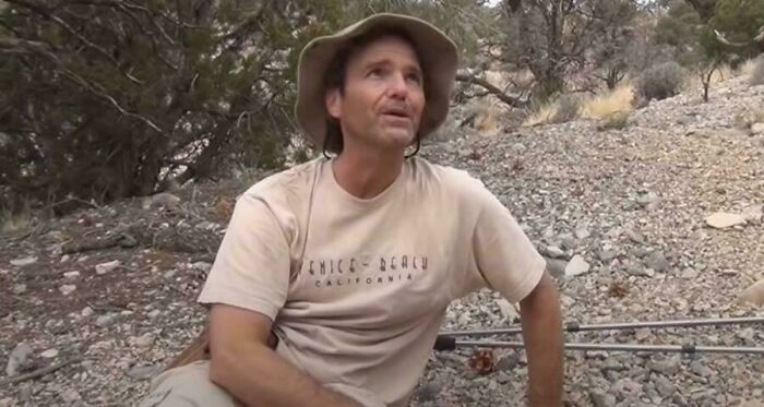 Man wearing a beige hat and t-shirt sitting outdoors in a story about terrifying real experiences