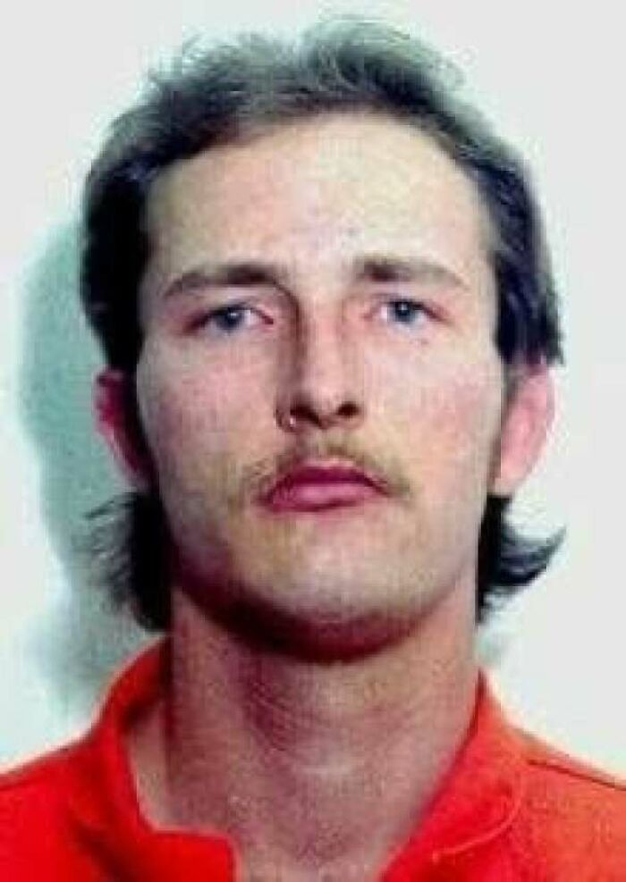 Mugshot of a man in orange prison clothes real horror story