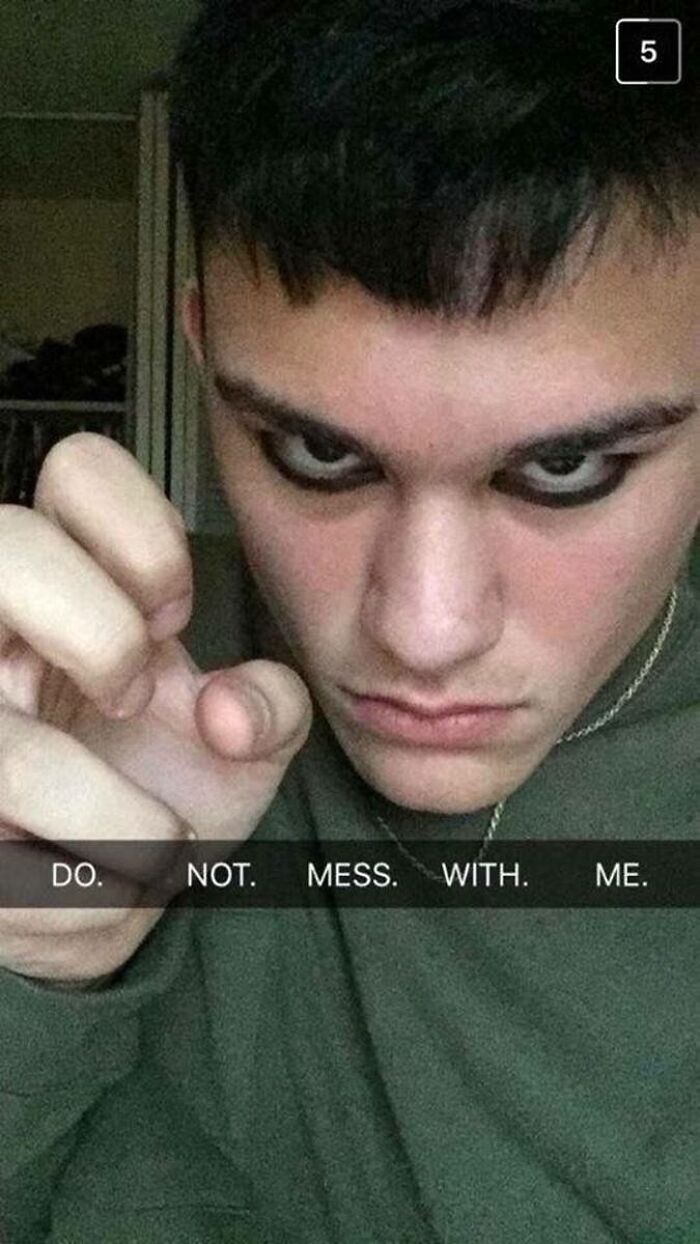 Young man acting tough with intense gaze and caption do not mess with me