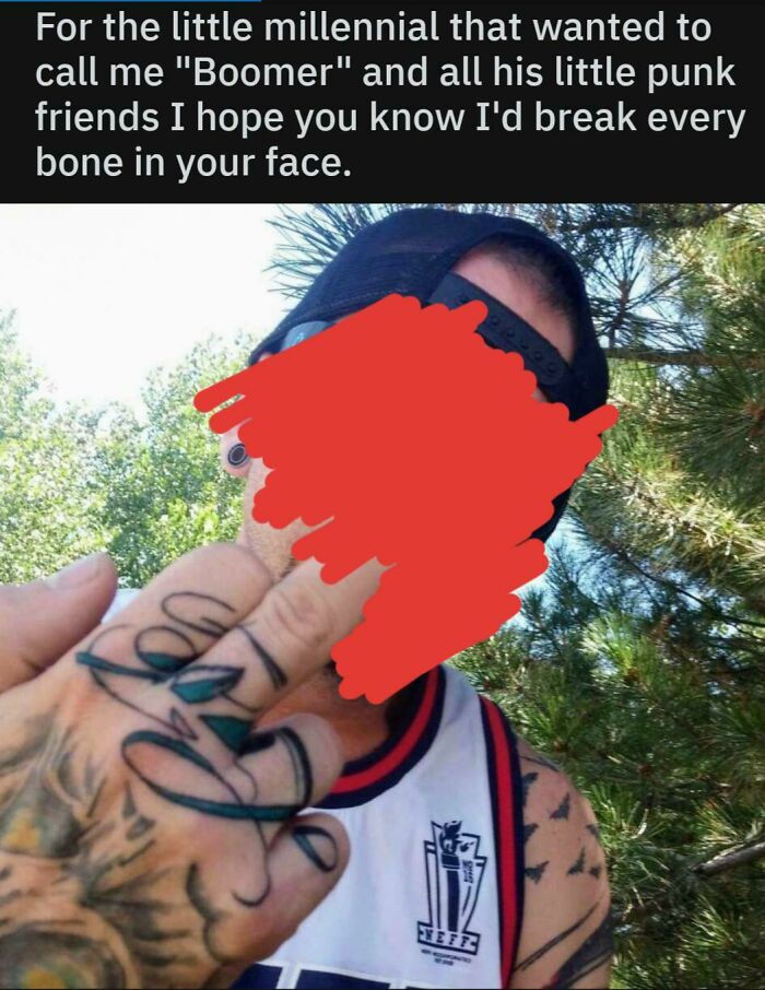 Man with tattoos flipping middle finger threatening millennials acting tough