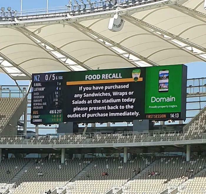 Stadium scoreboard food recall notice about sandwiches wraps and salads