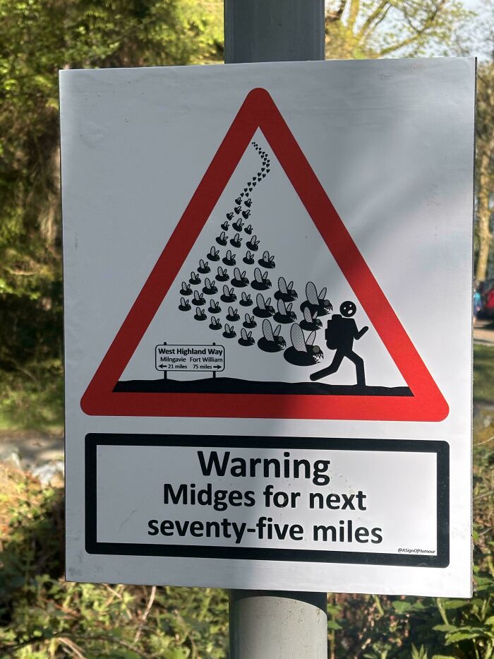 Humorous warning sign about midges for the next seventy-five miles