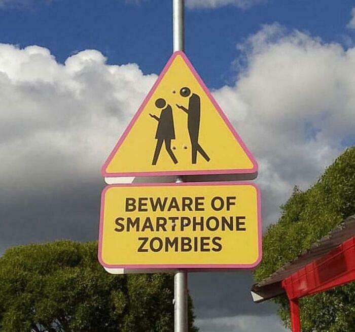 Warning sign about smartphone zombies distracted by phones