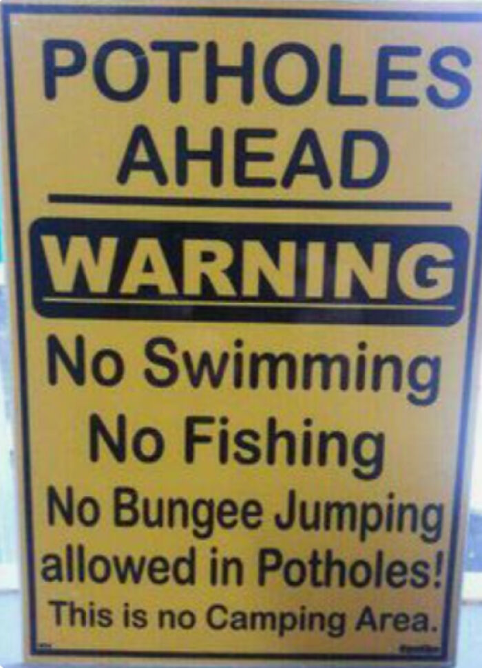 Warning sign humor about potholes banning swimming fishing and bungee jumping
