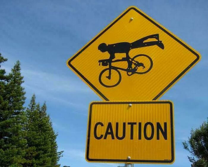 Comical caution sign showing bicyclist falling off bike