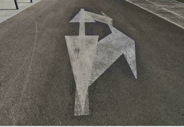 Confusing road arrow marking with multiple conflicting directions