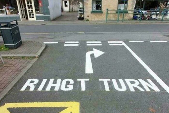 Road sign with misspelled right turn instructions on pavement