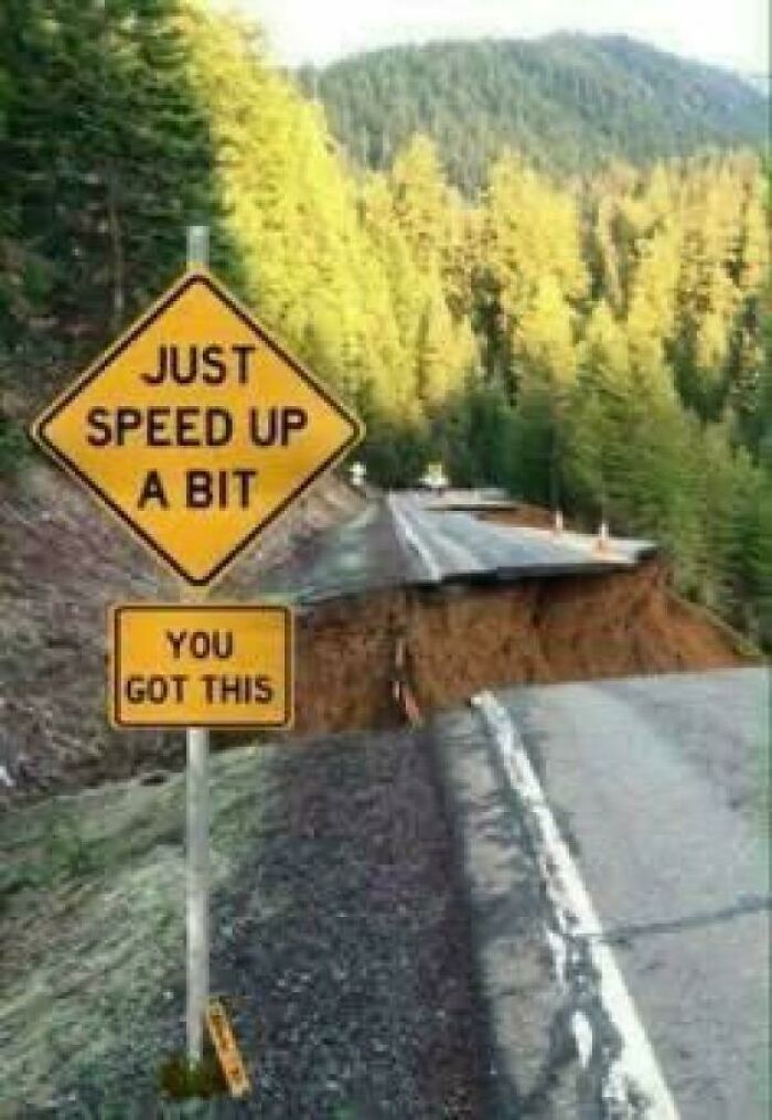 Humorous road sign urging drivers to speed up near road collapse