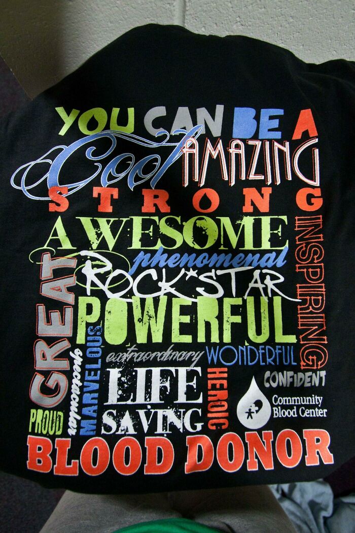 A black t-shirt with numerous positive words and 'Blood Donor' in various fonts, showcasing bad clothing design.