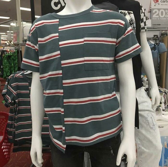 Clothing design: A mannequin in a store, modeling a striped t-shirt with a mismatched vertical seam creating a bad clothing design.