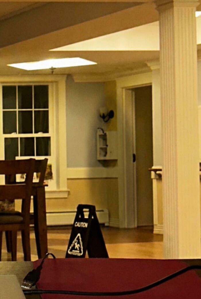 Empty room with caution sign and odd lighting for spooky horror scene