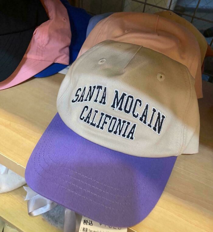 A two-toned cap with embroidered, misspelled location text. An example of bad clothing designs.