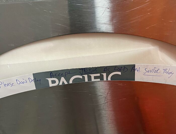 A handwritten message on a baggage carousel: 'Accept Jesus as Lord And Savior Today,' adding to chaotic airport scenes.
