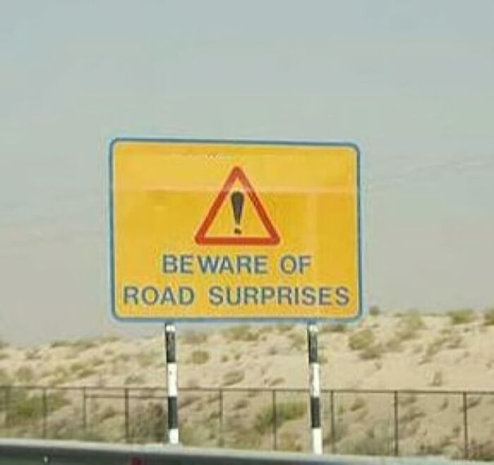Funny road sign warning of road surprises ahead